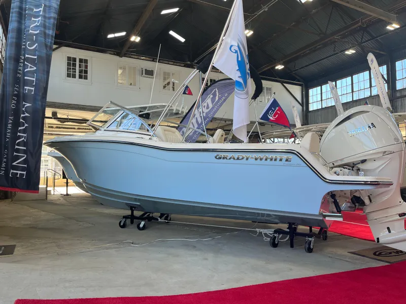 The Image of 2025 Grady-White Freedom 215 boat displayed indoors on red carpet. - 0