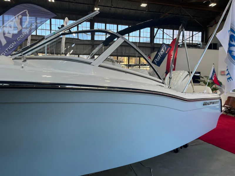 Slide: The Image of 2025 Grady-White Freedom 215 boat displayed indoors at a marine exhibition. - 4