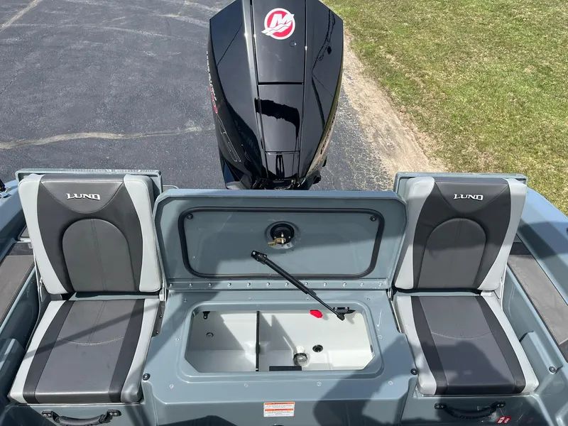 Slide: The Image of 2025 Lund 185 Impact GL boat interior with seating and motor. - 10