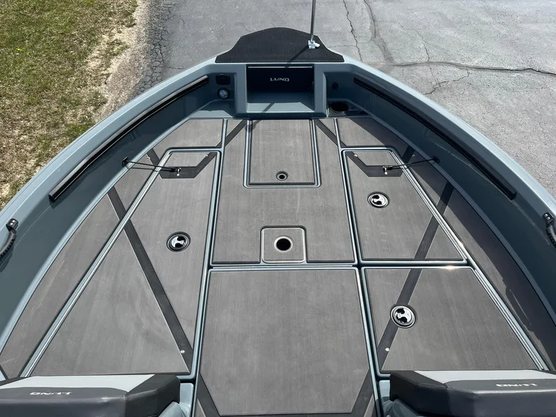 Slide: The Image of 2025 Lund 185 Impact GL boat deck with storage compartments and sleek design. - 12