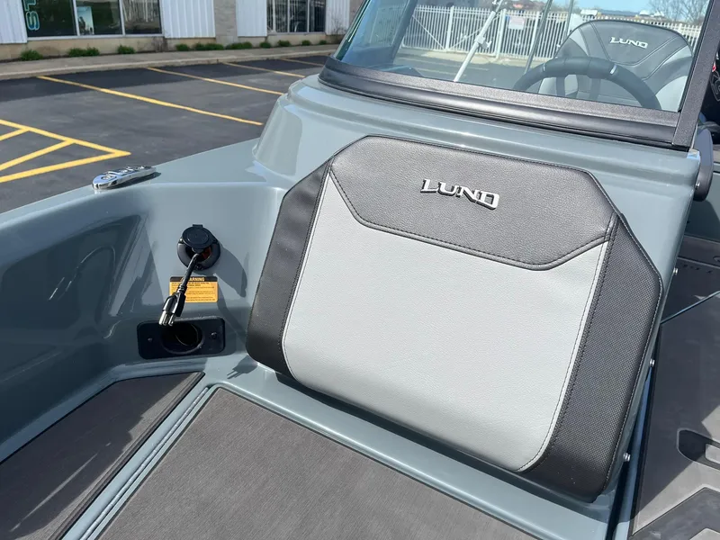 Slide: The Image of 2025 Lund 185 Impact GL boat interior with branded seating and dashboard view. - 20