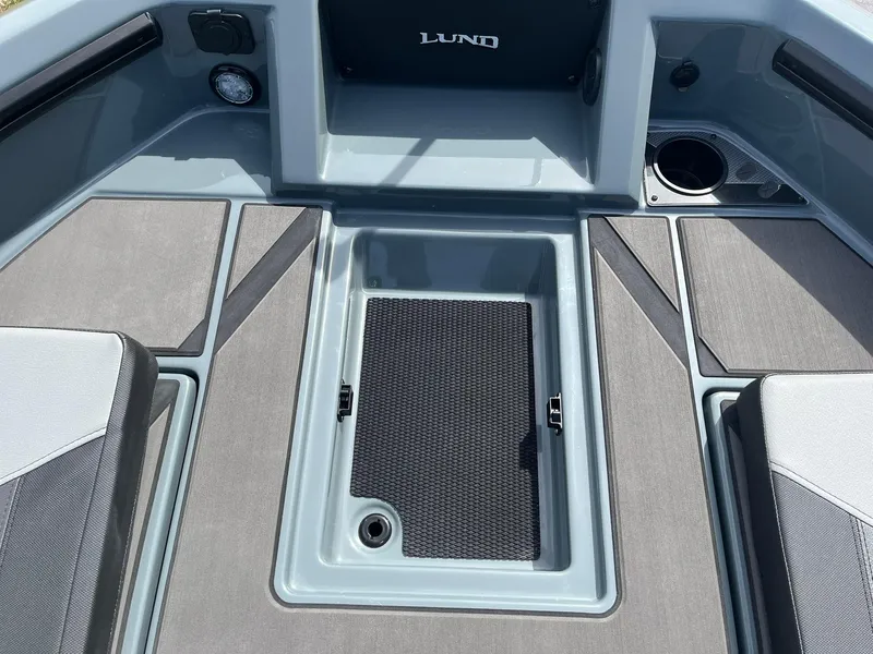 Slide: The Image of 2025 Lund 185 Impact GL boat interior with storage compartment and seating. - 21