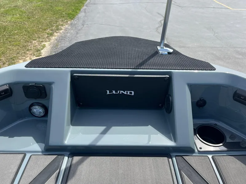 Slide: The Image of 2025 Lund 185 Impact GL boat dashboard with storage compartment and cup holder. - 22