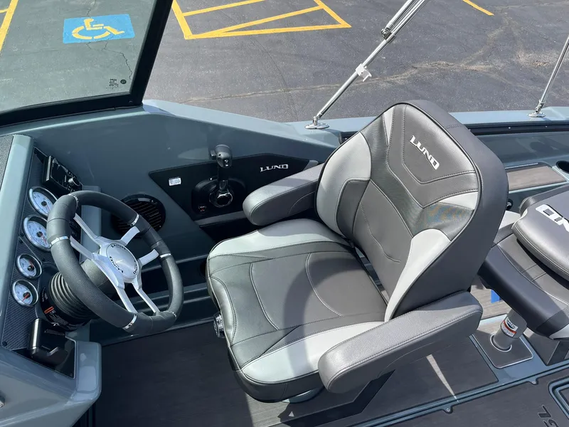 Slide: The Image of 2025 Lund 185 Impact GL boat interior with steering wheel and comfortable seating. - 24