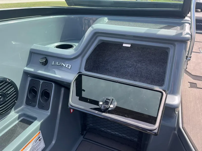 Slide: The Image of 2025 Lund 185 Impact GL boat dashboard with storage compartment and cup holder. - 30