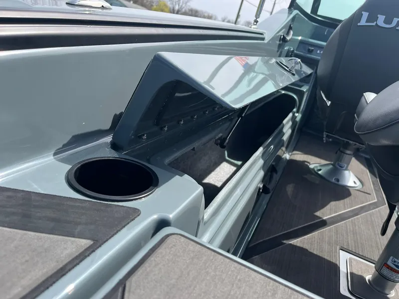 Slide: The Image of 2025 Lund 185 Impact GL boat interior with storage compartment and cup holder. - 32