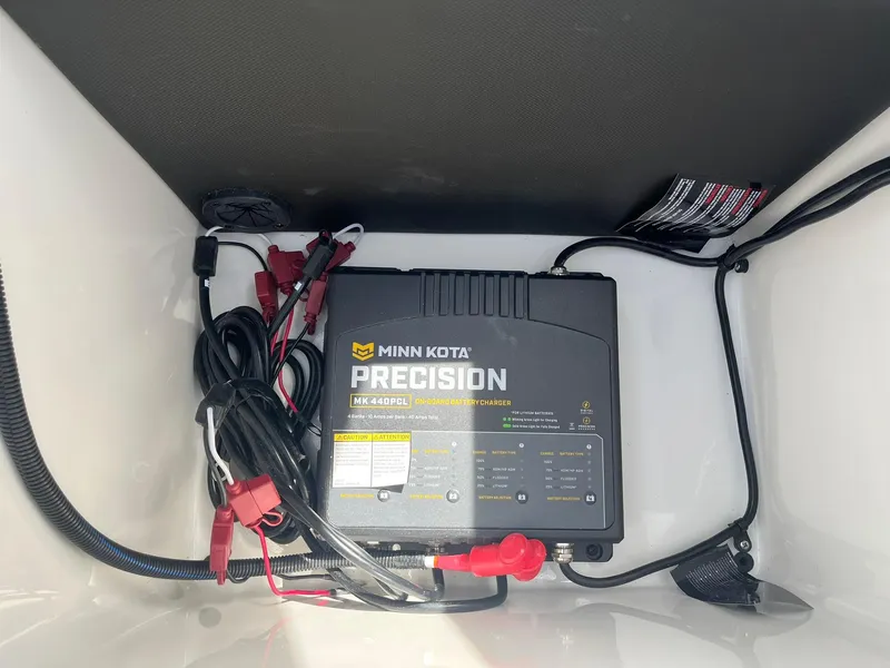 Slide: The Image of Minn Kota Precision charger in 2025 Lund 185 Impact GL boat compartment. - 34