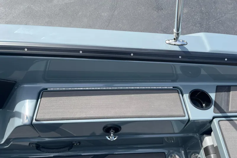 Slide: The Image of 2025 Lund 185 Impact GL boat interior with storage compartment and cup holder. - 35