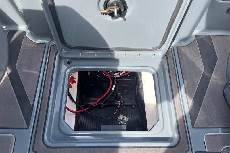 Slide: The Image of 2025 Lund 185 Impact GL boat battery compartment with wiring and secure hatch. - 36