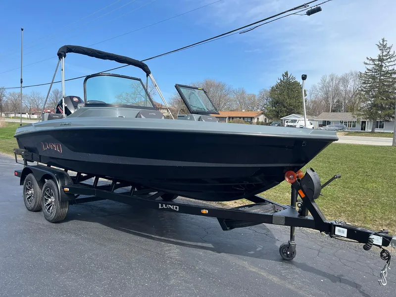 Slide: The Image of 2025 Lund 185 Impact GL boat on trailer, parked outdoors. - 4