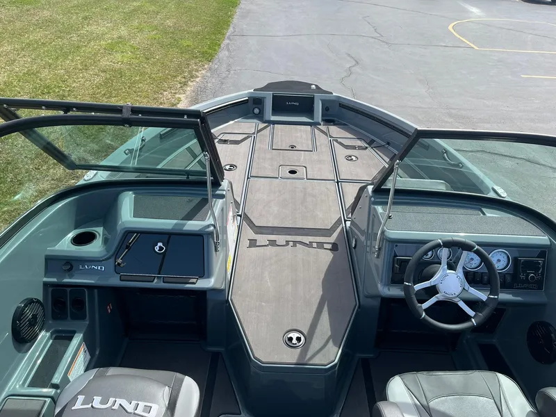 Slide: The Image of 2025 Lund 185 Impact GL boat interior with steering wheel and seating. - 8