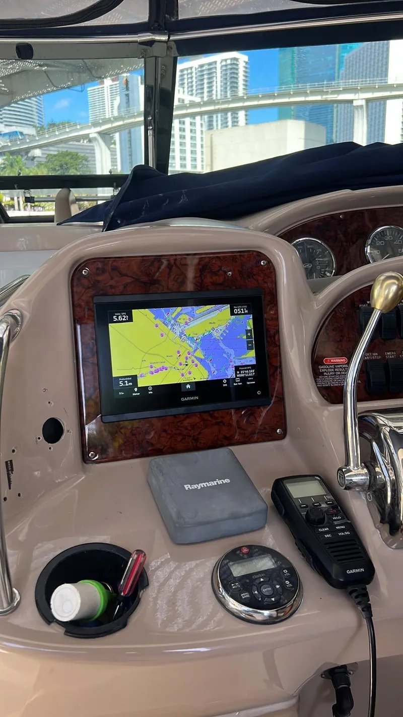 Slide: The Image of Control panel of a 2004 Sea Ray 360 Sundancer with navigation equipment. - 11