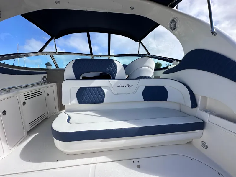 Slide: The Image of Interior of 2004 Sea Ray 360 Sundancer yacht with blue and white seating. - 13