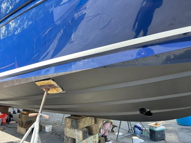 Slide: The Image of 2004 Sea Ray 360 Sundancer boat hull on blocks, undergoing maintenance. - 16