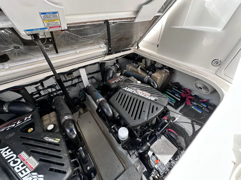Slide: The Image of Engine compartment of 2004 Sea Ray 360 Sundancer with Mercury engines. - 18