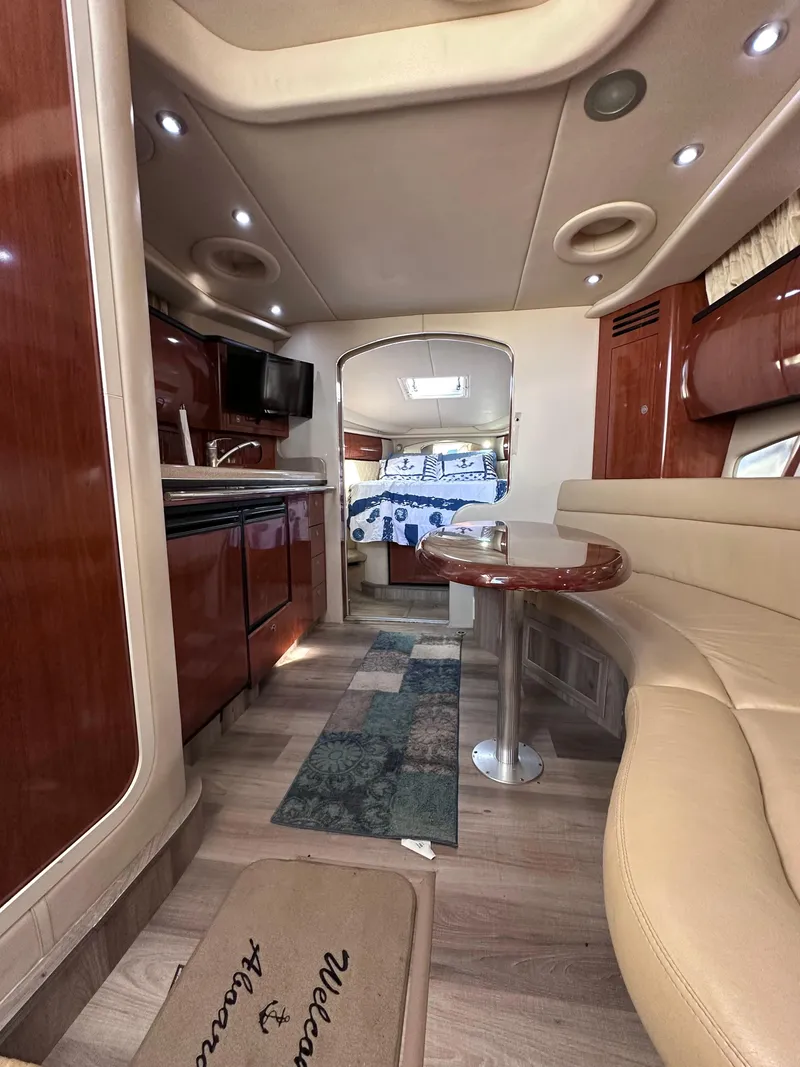 Slide: The Image of Interior of 2004 Sea Ray 360 Sundancer yacht with modern amenities and cozy seating. - 19
