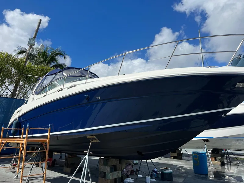 Slide: The Image of 2004 Sea Ray 360 Sundancer yacht on dry dock under a clear blue sky. - 2