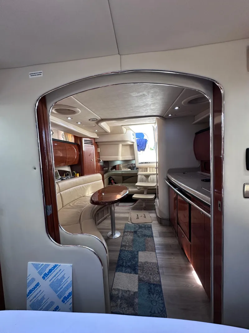 Slide: The Image of Interior of 2004 Sea Ray 360 Sundancer yacht with elegant seating and kitchenette. - 23