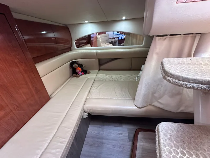 Slide: The Image of Interior of 2004 Sea Ray 360 Sundancer with beige seating and wooden accents. - 24