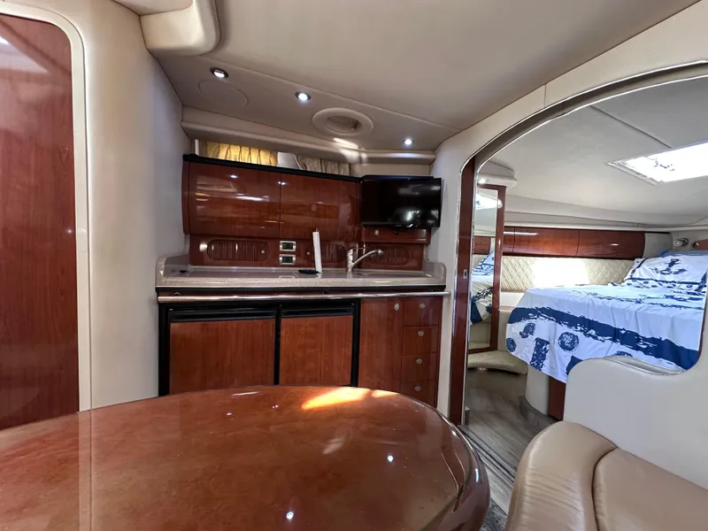 Slide: The Image of Luxurious interior of 2004 Sea Ray 360 Sundancer yacht with kitchenette and cozy sleeping area. - 25
