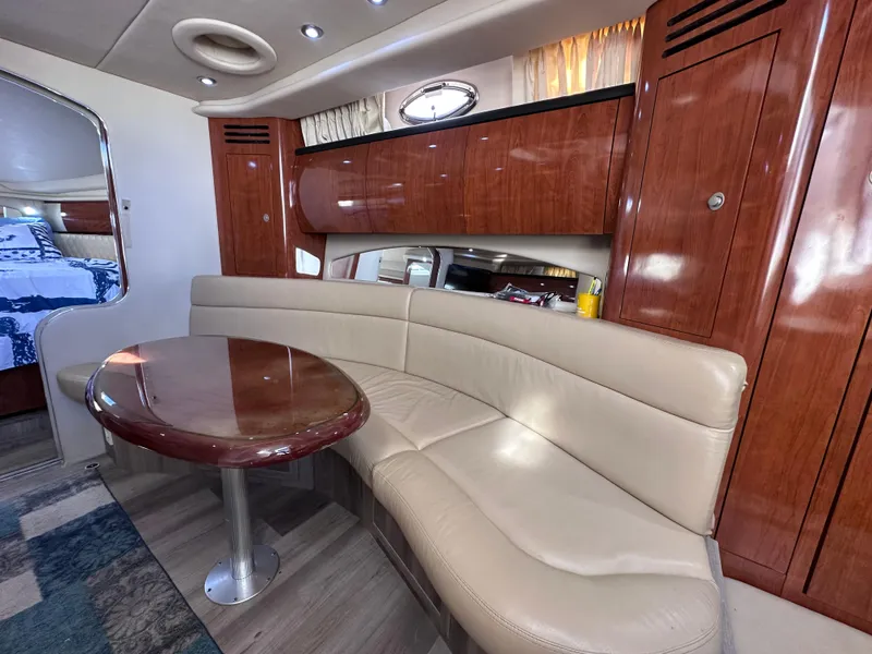 Slide: The Image of Luxurious interior of 2004 Sea Ray 360 Sundancer with leather seating and wooden cabinetry. - 26