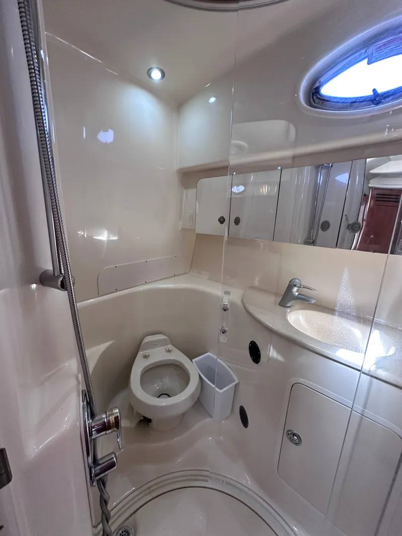 Slide: The Image of 2004 Sea Ray 360 Sundancer bathroom with toilet, sink, and shower. - 28
