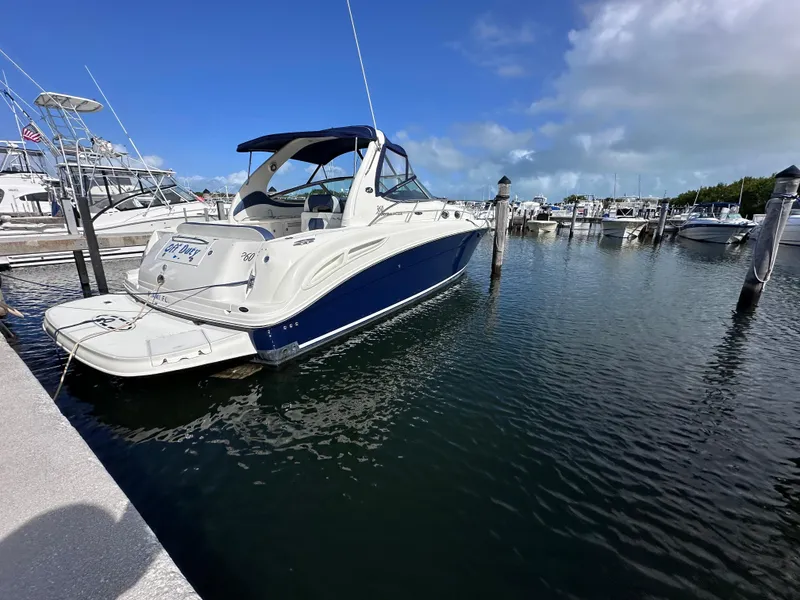 Slide: The Image of 2004 Sea Ray 360 Sundancer yacht docked at marina under blue sky. - 4
