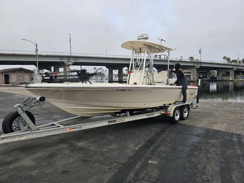 Slide: The Image of 2014 Pathfinder 2600 HPS boat on trailer near a bridge. - 2