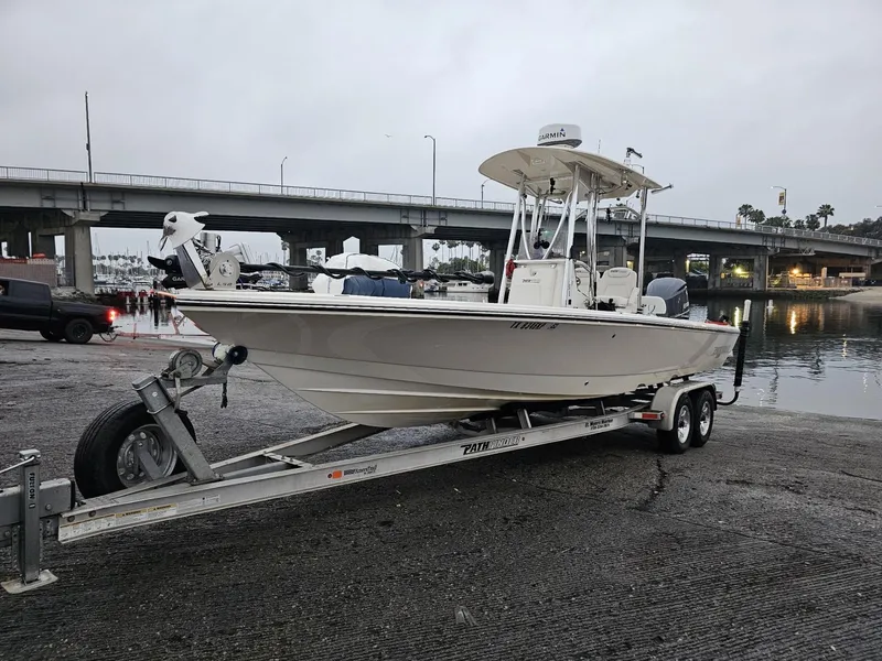 Slide: The Image of 2014 Pathfinder 2600 HPS boat on trailer near waterfront and bridge. - 3