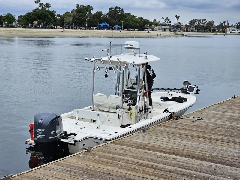 Slide: The Image of 2014 Pathfinder 2600 HPS boat docked by a calm waterfront. - 4