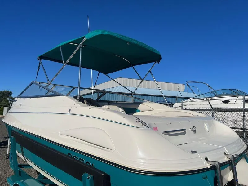 Slide: The Image of 1995 Regal Valanti 222 boat with teal canopy, docked outdoors. - 19