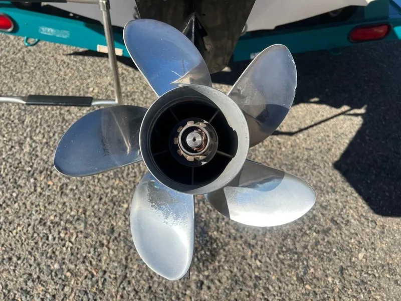 Slide: The Image of Close-up of a Regal Valanti 222 boat propeller, 1995 model, on a gravel surface. - 20