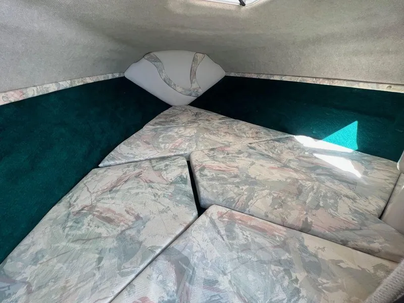 Slide: The Image of Interior cabin of 1995 Regal Valanti 222 boat with cushioned seating. - 21