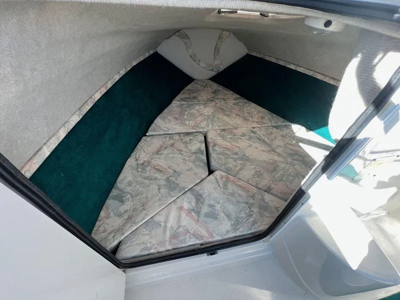 Slide: The Image of 1995 Regal Valanti 222 cabin interior with patterned cushions and green accents. - 22