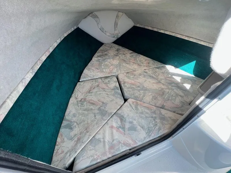 Slide: The Image of Interior cabin of 1995 Regal Valanti 222 boat with cushioned seating. - 23