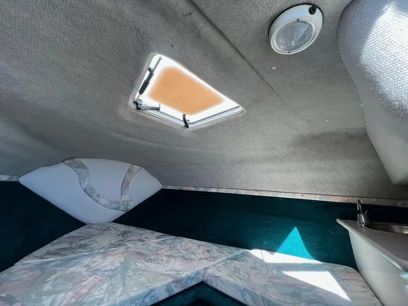 Slide: The Image of Interior cabin of 1995 Regal Valanti 222 boat with skylight and seating area. - 25