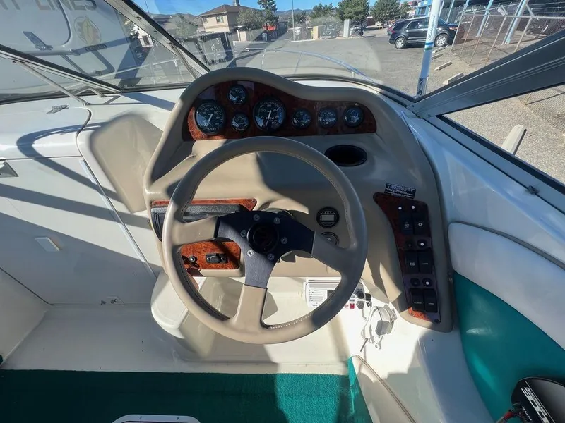Slide: The Image of 1995 Regal Valanti 222 boat dashboard with steering wheel and instrument panel. - 30