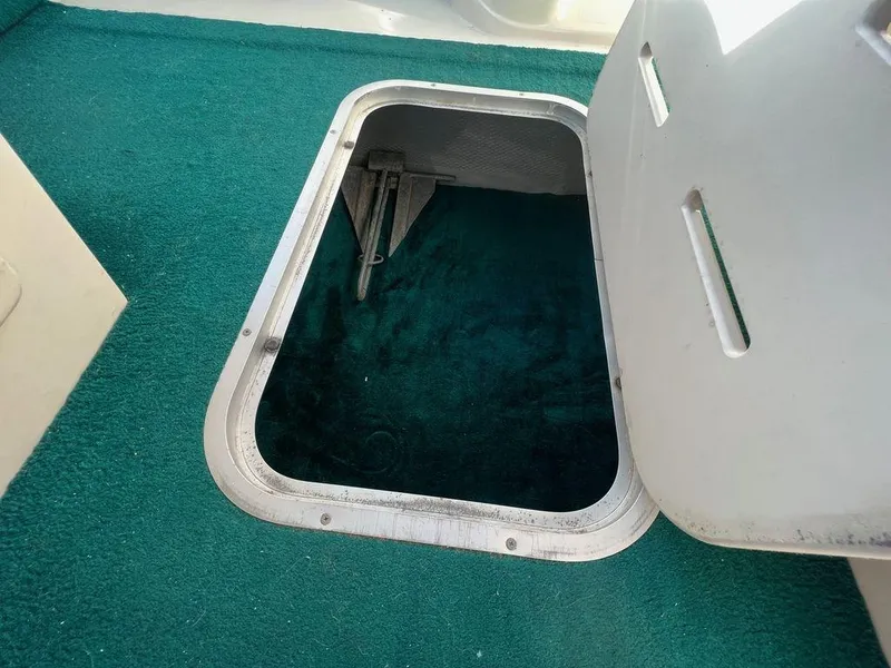 Slide: The Image of Open storage compartment on 1995 Regal Valanti 222 boat with green carpet interior. - 31
