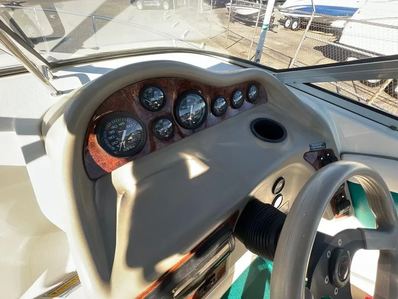 Slide: The Image of 1995 Regal Valanti 222 boat dashboard with gauges and steering wheel. - 33