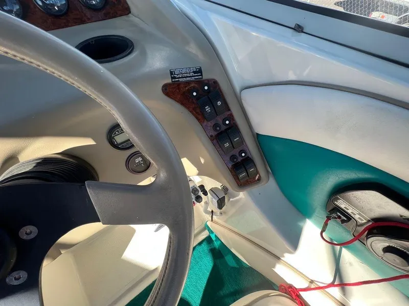 Slide: The Image of Interior dashboard of a 1995 Regal Valanti 222 boat, featuring steering wheel and control panel. - 34