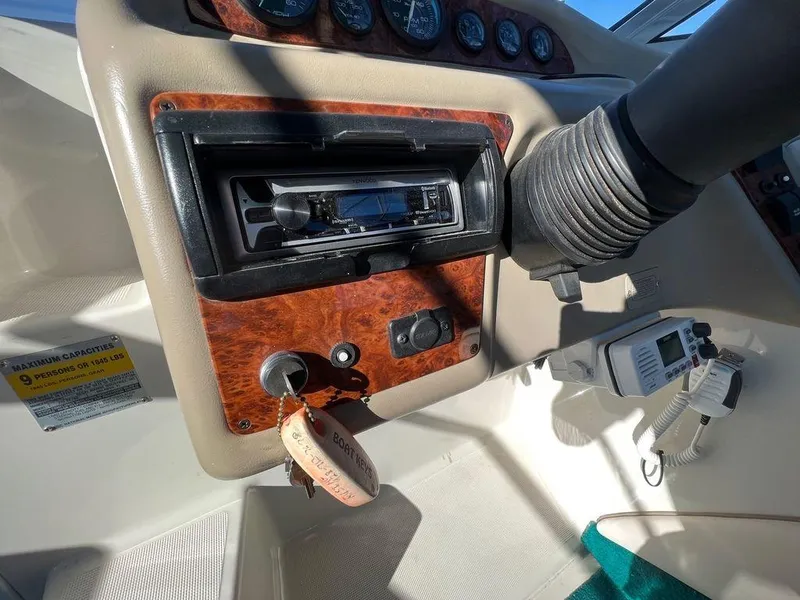 Slide: The Image of 1995 Regal Valanti 222 boat dashboard with stereo and ignition key. - 35