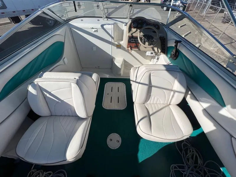 Slide: The Image of 1995 Regal Valanti 222 boat interior with white seats and teal accents. - 36