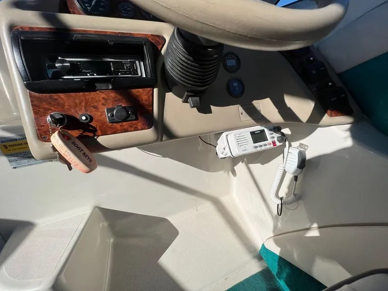 Slide: The Image of 1995 Regal Valanti 222 boat dashboard with steering wheel and control panel. - 37