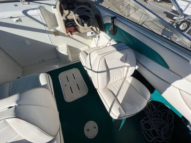 Slide: The Image of Interior of a 1995 Regal Valanti 222 boat with white seating and green flooring. - 38