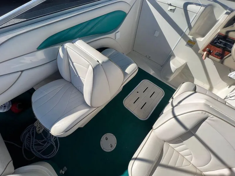 Slide: The Image of Interior of 1995 Regal Valanti 222 boat with white seats and green accents. - 39