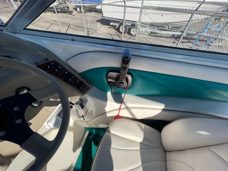 Slide: The Image of Interior of a 1995 Regal Valanti 222 boat, featuring steering wheel and control panel. - 40