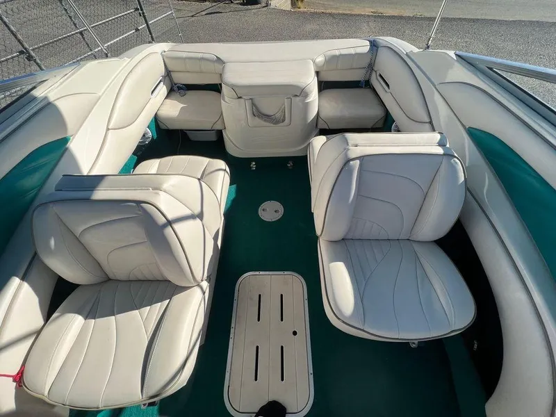 Slide: The Image of Interior of a 1995 Regal Valanti 222 boat with white leather seating. - 42