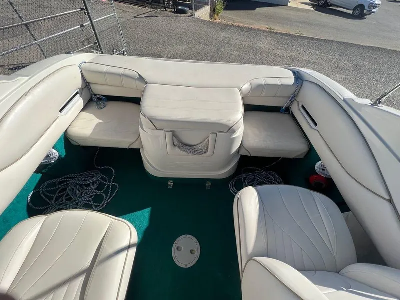 Slide: The Image of Interior of a 1995 Regal Valanti 222 boat with white seating and green carpet. - 43