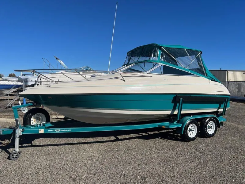 Slide: The Image of 1995 Regal Valanti 222 boat on trailer, teal and white design, parked outdoors. - 45