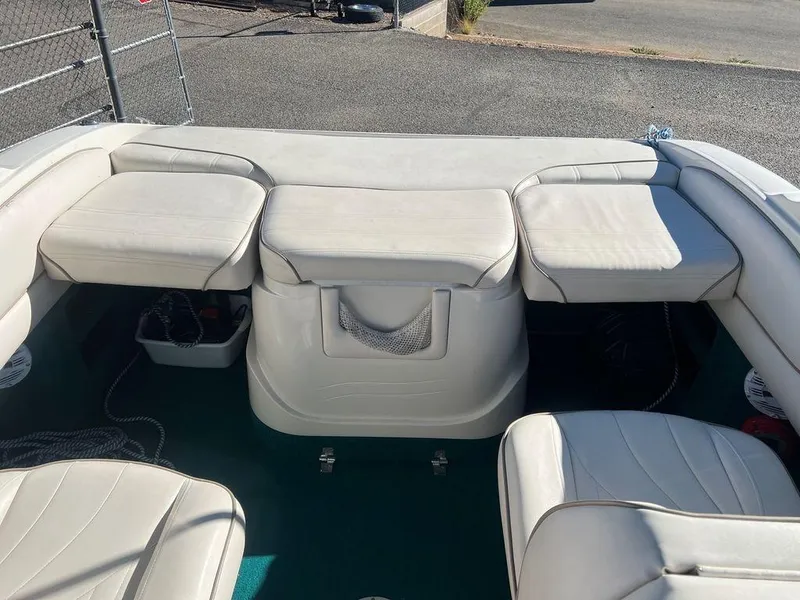 Slide: The Image of Interior seating of a 1995 Regal Valanti 222 boat with white upholstery. - 46